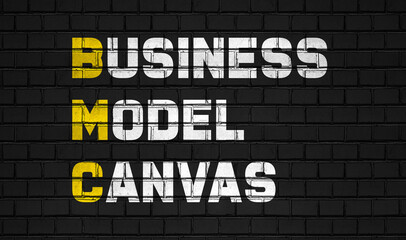 Business model canvas (BMC) concept ,business abbreviations on black wall 