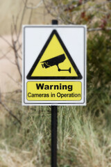 camera surveillance warning sign outdoors