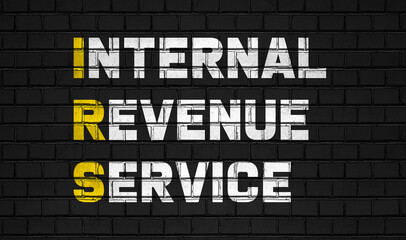 Internal revenue service (IRS) concept,business abbreviations on black wall 
