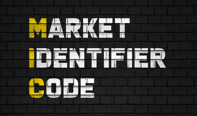 Market identifier code (MIC) concept,business abbreviations on black wall 
