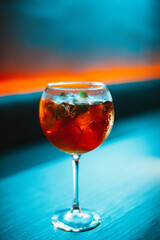 glass of red wine on blue background