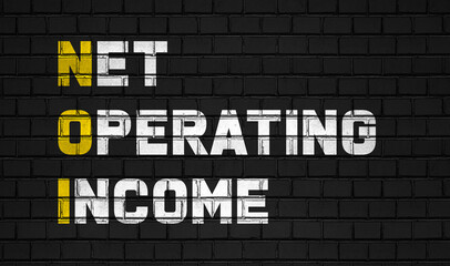 Net operation income (NOI) concept,business abbreviations on black wall 
