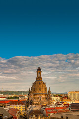 Cover page with bird view of the church of our Lady (Frauenkirche) at Neumarkt square in historical downtown of Dresden in summer with blue sky and sunset, Germany.