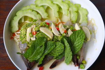 Thai food recipe, shrimp in fish sauce with peppermint, chili and bitter melon slices.  Popular Thai seafood in restaurant.