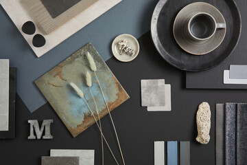 Creative flat lay composition with textile and paint samples, panels and tiles. Stylish interior designer moodboard. Black, blue, beige and dark grey color palette. Copy space. Template. .