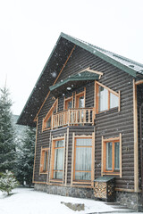 Wooden house in mountains in snowy day