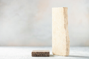Composition of travertine and granite blocks. Abstract modern background. Natural materials.