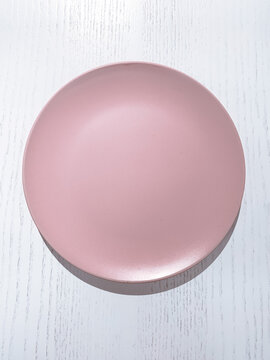 Empty Pink Plate On A White Background