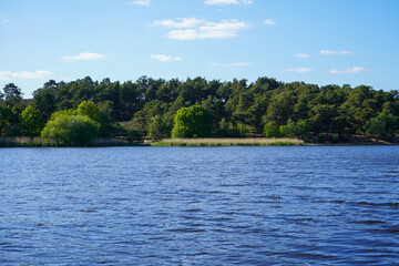 View over a blue lake and woodland