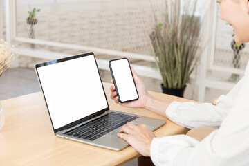 computer screen,cell phone blank mockup.hand woman work using laptop texting mobile.white background for advertising,contact business search information on desk in cafe.marketing,design