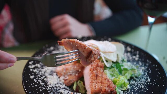 fresh delicious caesar salad with lettuce, grilled chicken, crusty bread toast