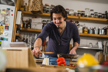 Fototapeta na wymiar man preparing food in his kitchen