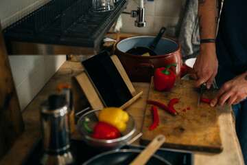 close up man cutting red paprika