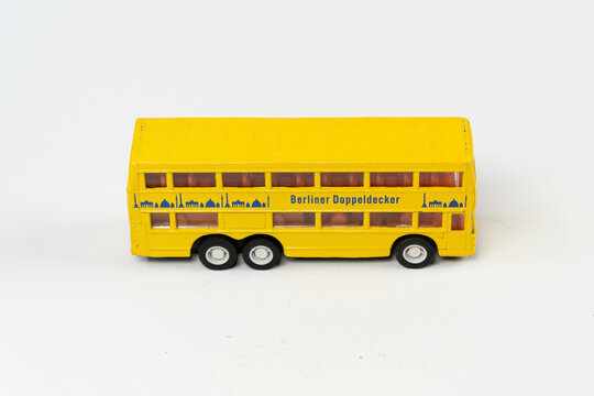 Yellow double decker metal bus, big tourist bus mini toy, isolated on white background