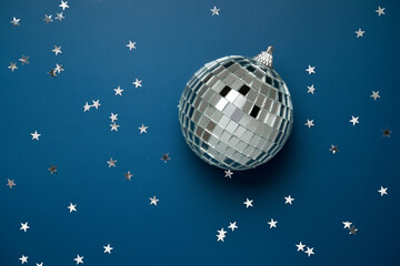 disco ball on dark blue background with silver stars. night sky concept , retro nightclub...