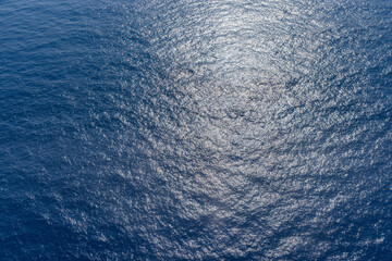 Deep blue dark blue sea texture background. Ocean surface in sunlight, relaxing nature pattern, ecology concept
