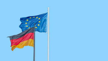 Banner with a national black red yellow flag of Germany and blue flag with stars of EU and at blue sky background with copy space, details, closeup. Concept of nationality, citizenship and patriotism.