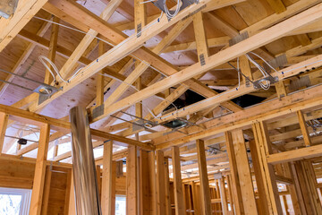 Framing of beams stick built house on new home under construction