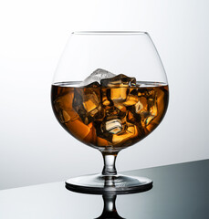 glass of whiskey with ice isolated on a white background