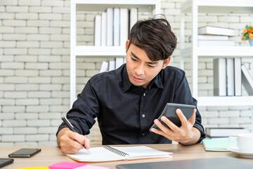 Asian businessman freelance using calculator for financial planning and accounting. Concept for working at home.