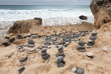 Stone cairns are at the sandy beach of Porto Santo