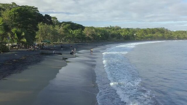 drone aerial of caribbean puerto viejo, Costa Rica black beach empty over water