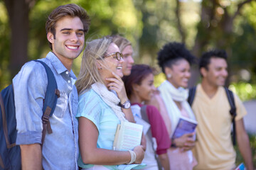 Excited about college. A group of students standing in a line on campus.