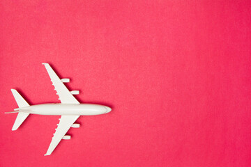 Airplane model. White plane on pink background. Travel vacation concept. Summer background. Flat...