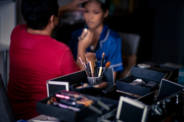 selective focus Make-up converter on makeup artist's table with lots of makeup artist tools. blur background makeup artist doing makeup beautiful girl There is space for text.