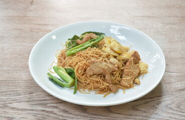 stir fried vermicelli thin rice noodles with slice fermenting pork and Chinese kale dressing black sweet soybean sauce on plate