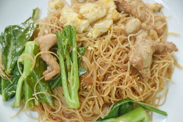 stir fried vermicelli thin rice noodles with slice fermenting pork and Chinese kale dressing black sweet soybean sauce on plate