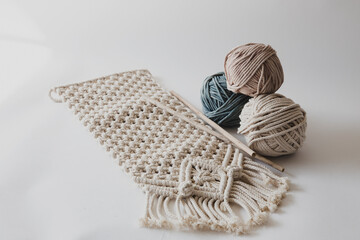 Handmade macrame on white background.