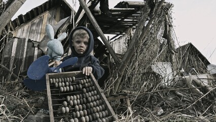 Child playing war in ruins 