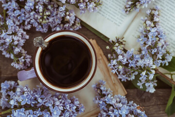 The postcard is beautiful. A fancy purple coffee mug, an old book and a bouquet of purple lilac....