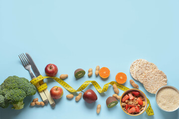 Composition with healthy products, cutlery and measuring tape on color background