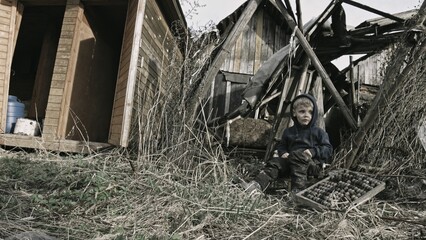 Child playing war in ruins 