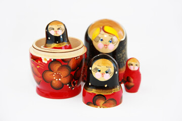 traditional Russian toy matryoshka doll with a floral pattern on a white background