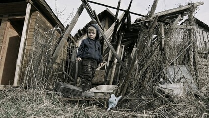 Fototapeta na wymiar Child playing war in ruins 