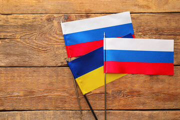 Flags of Russia and Ukraine on wooden background
