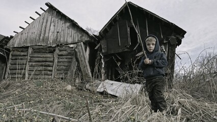Child playing war in ruins 