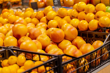 Citrus in boxes. Oranges, grapefruits, tangerines. Blurred background. Sale of fruit in the market. Vitamin C. Treatment of coronavirus.