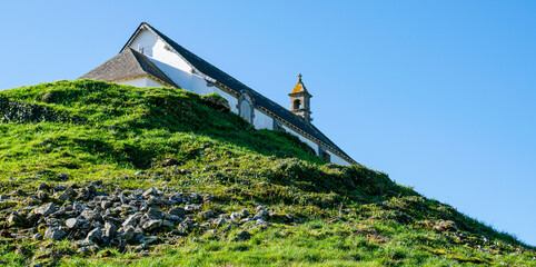 Carnac,France;February 26, 2022:Tumulus Saint Michel and its chapel, a site located in Morbihan in Brittany, the town is known for its alignments of 2,934 menhirs.