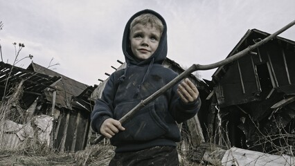 Child playing war in ruins