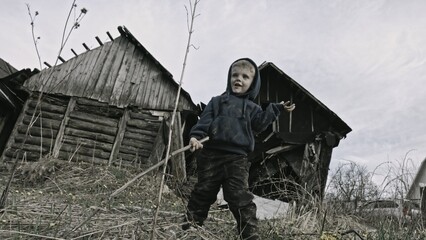 Child playing war in ruins