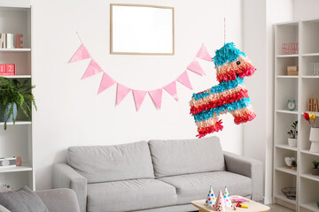 Mexican pinata hanging in living room decorated for Birthday party