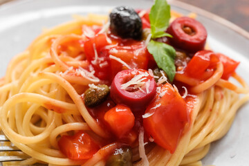 Plate with delicious Pasta Puttanesca, closeup