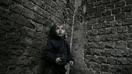 Child playing war in ruins