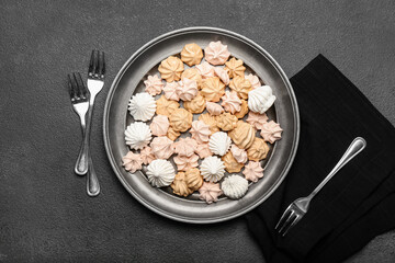 Plate with sweet meringue on dark background