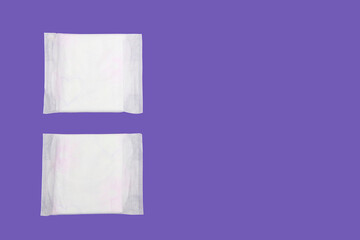 women's white sanitary pads for menstruation on a purple background very peri © Mari