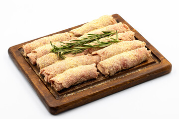 Beef schnitzel isolated on white background. Delicious raw meat schnitzel prepared with breadcrumbs and white sesame